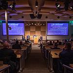 An audience watches a group of panelists give a presentation on stage at Central Florida's Second Annual Immersive Technology Summit.